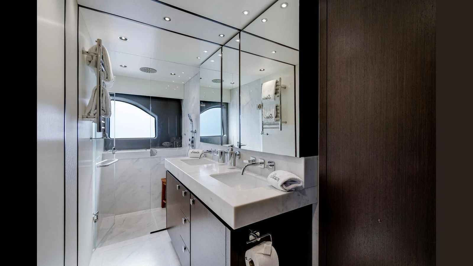 The yacht's bathroom features a sleek, modern design with a double sink and luxurious fixtures. aboard STEELN Yacht for Sale