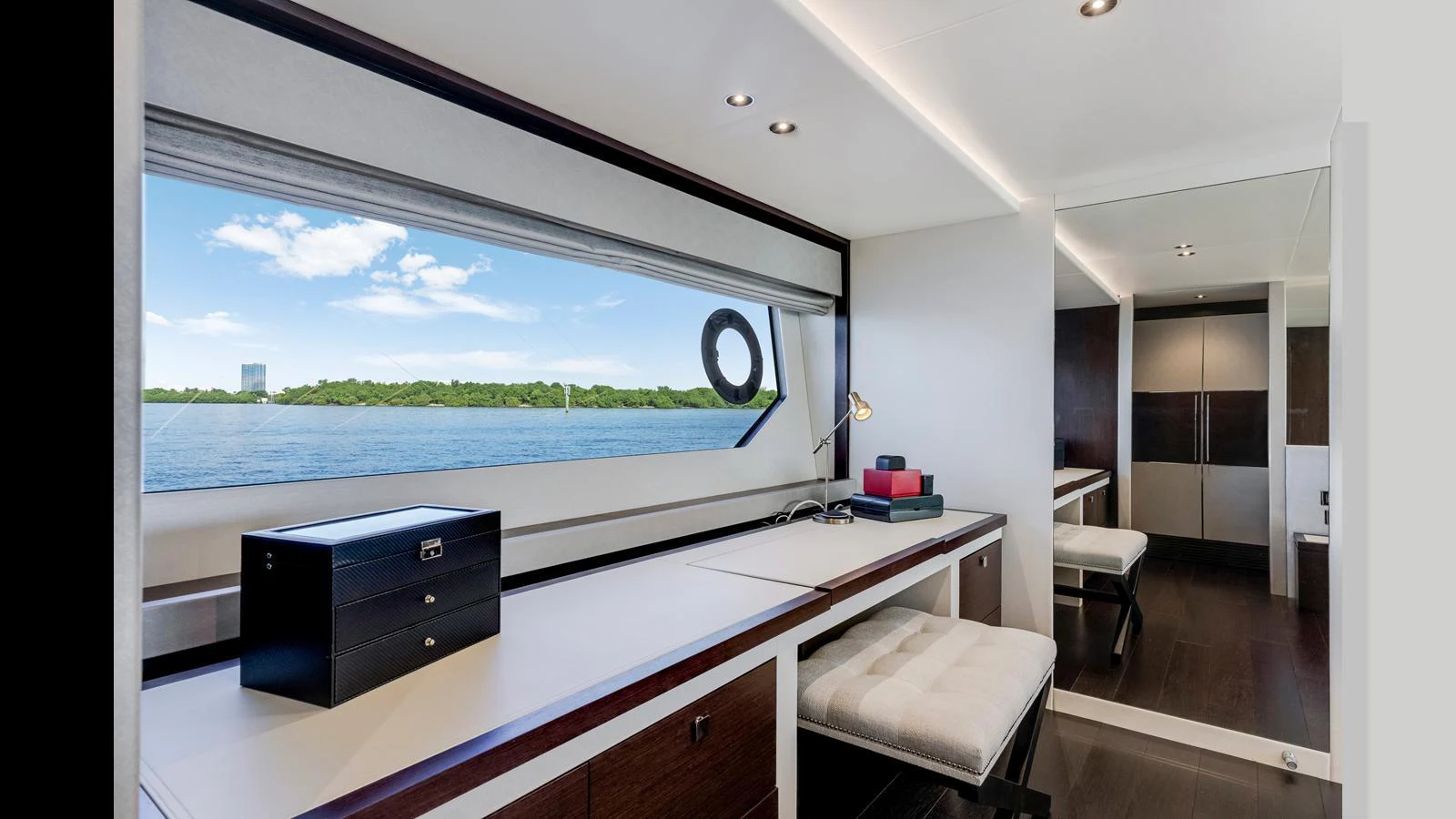 A sleek and modern interior space with a large window offering a scenic view of the water. aboard STEELN Yacht for Sale