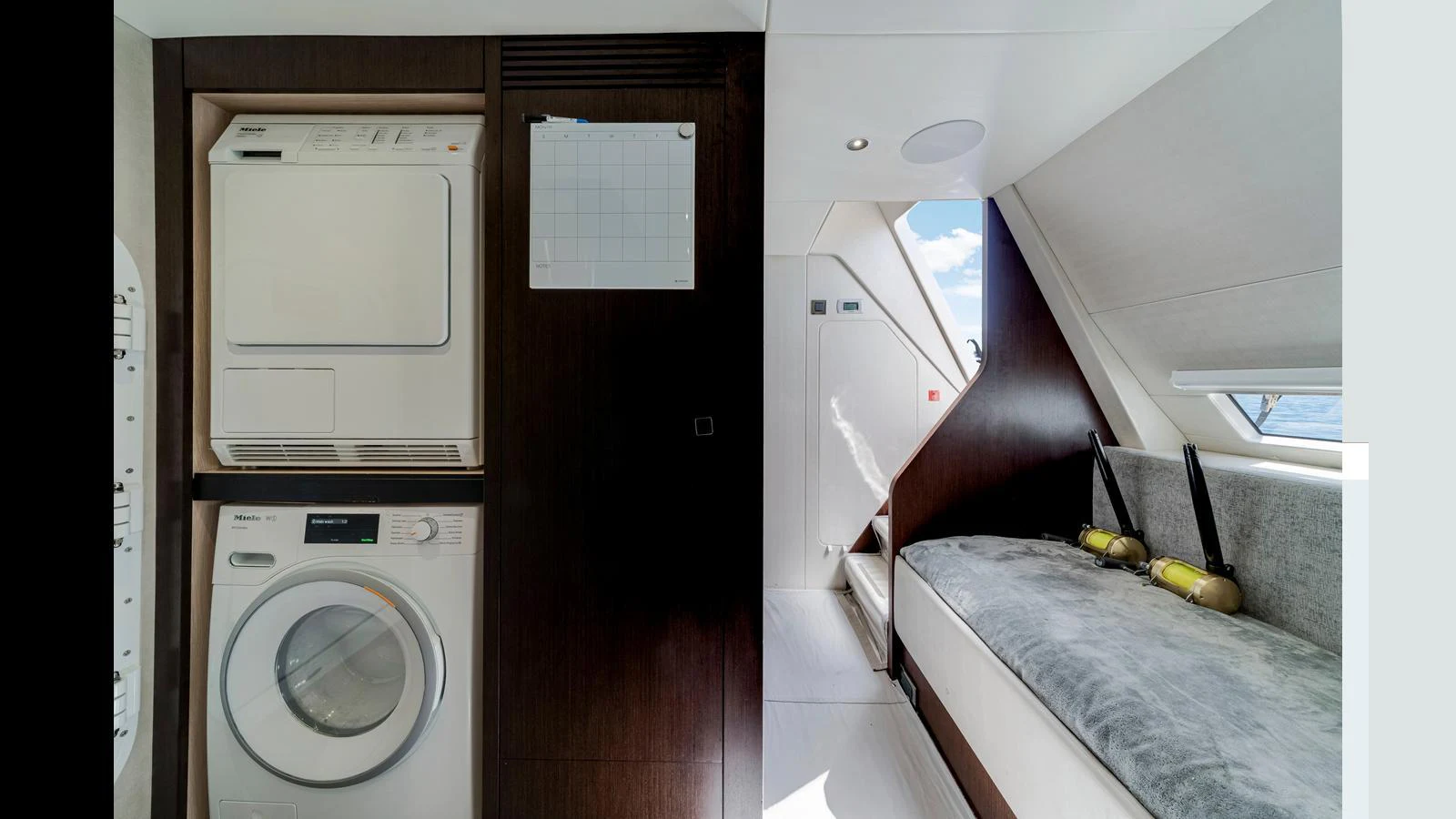 The yacht's interior features a laundry area with a washer and dryer, alongside a cozy seating nook. aboard STEELN Yacht for Sale