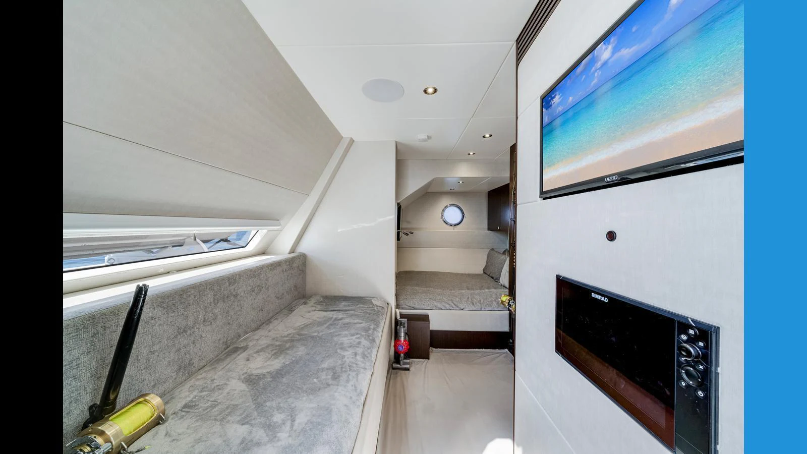 A cozy cabin with a comfortable seating area and a mounted flat-screen TV. aboard STEELN Yacht for Sale