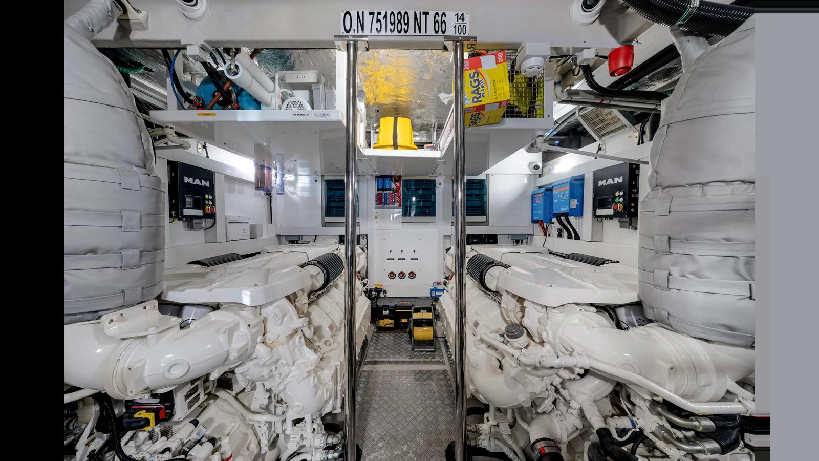 The image showcases the yacht's engine room with two large engines and various control panels. aboard STEELN Yacht for Sale
