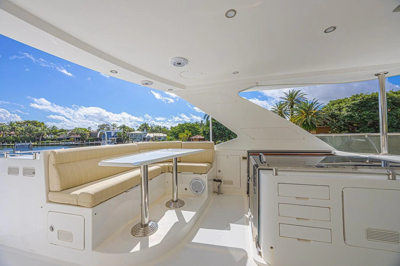 The flybridge features a comfortable seating area with a table and a well-equipped kitchenette. aboard MARGARITA Yacht for Sale
