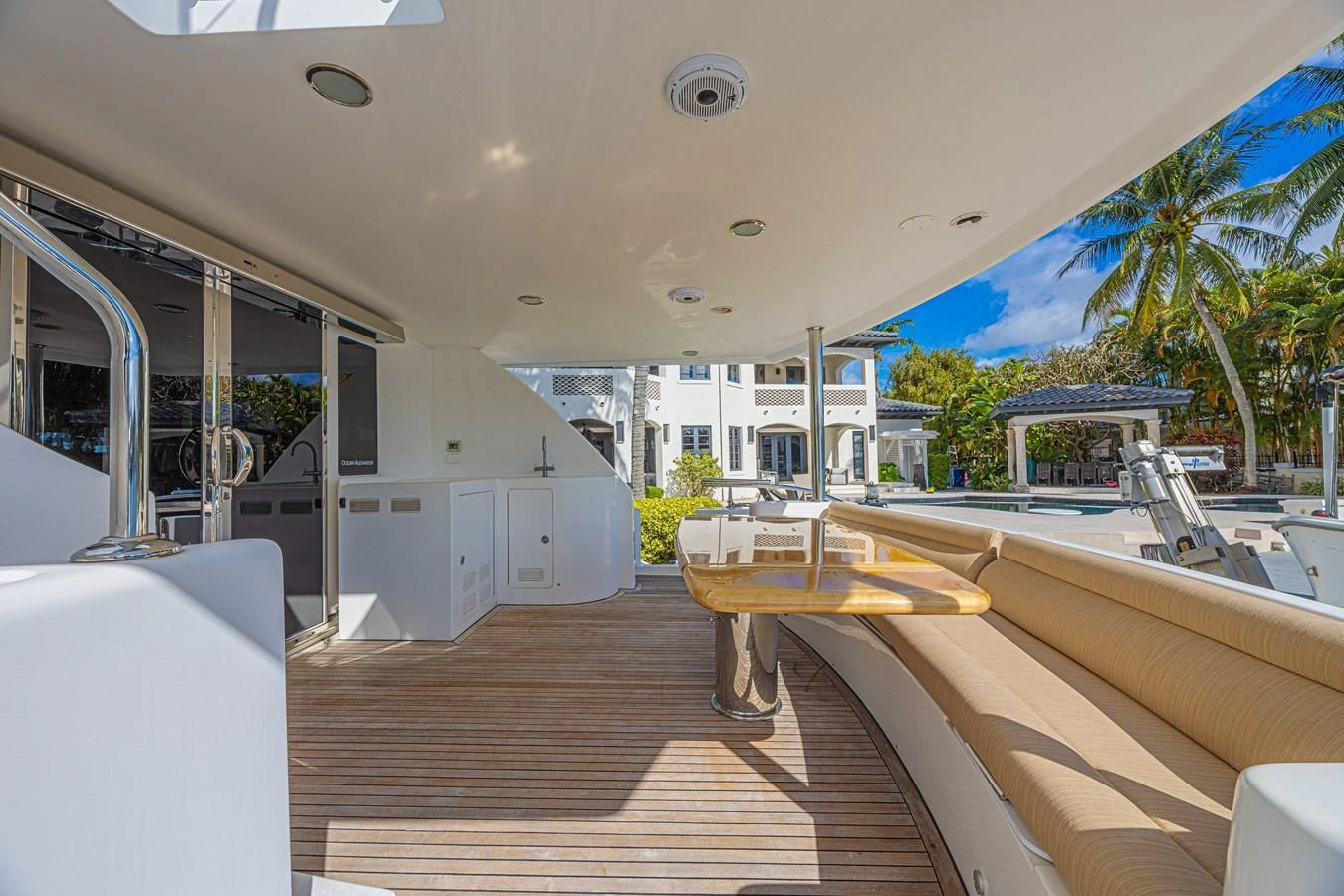 The aft deck features a spacious seating area with a wooden table, perfect for outdoor relaxation and dining. aboard MARGARITA Yacht for Sale