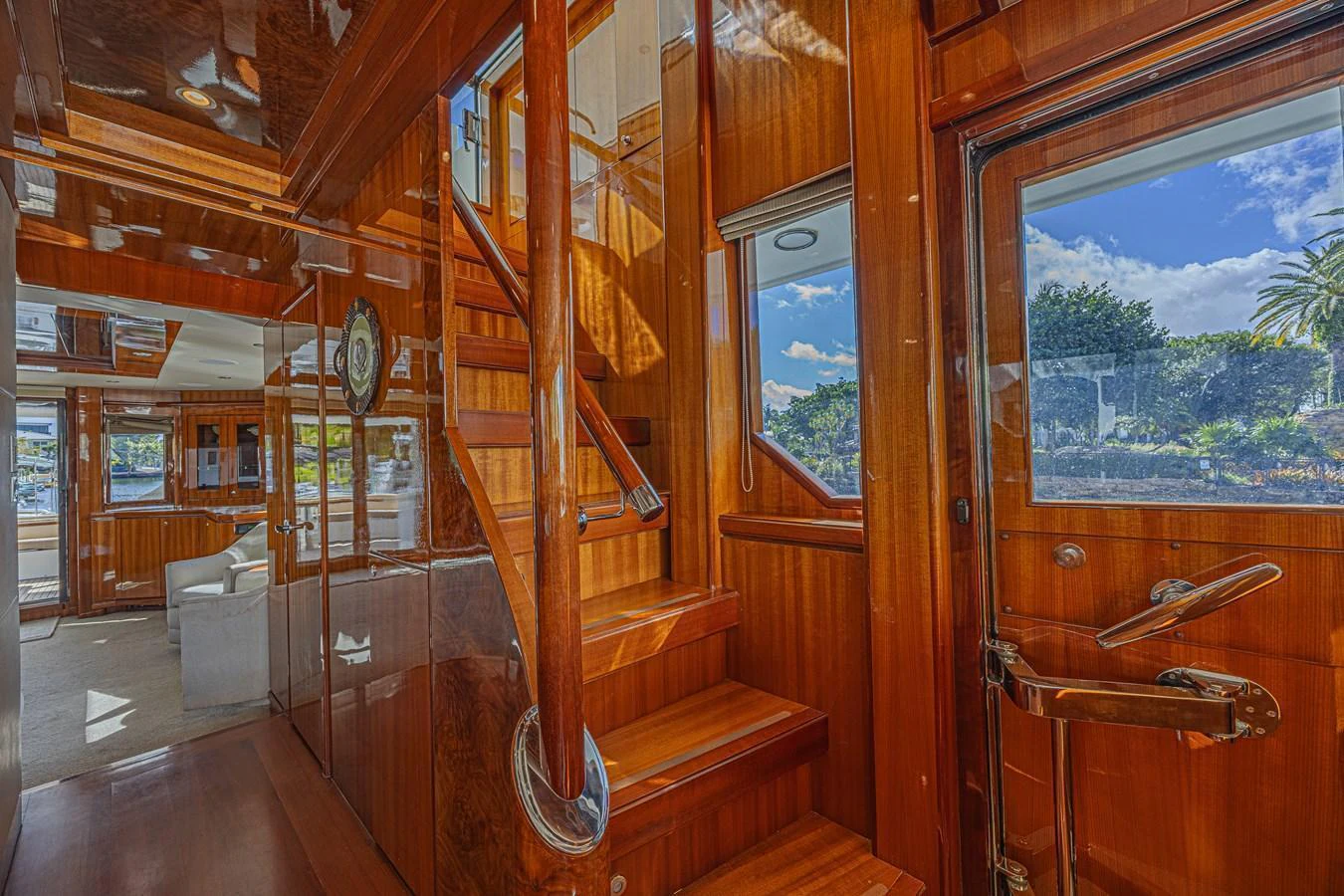 The yacht's interior features a beautifully crafted wooden staircase leading to the upper deck. aboard MARGARITA Yacht for Sale