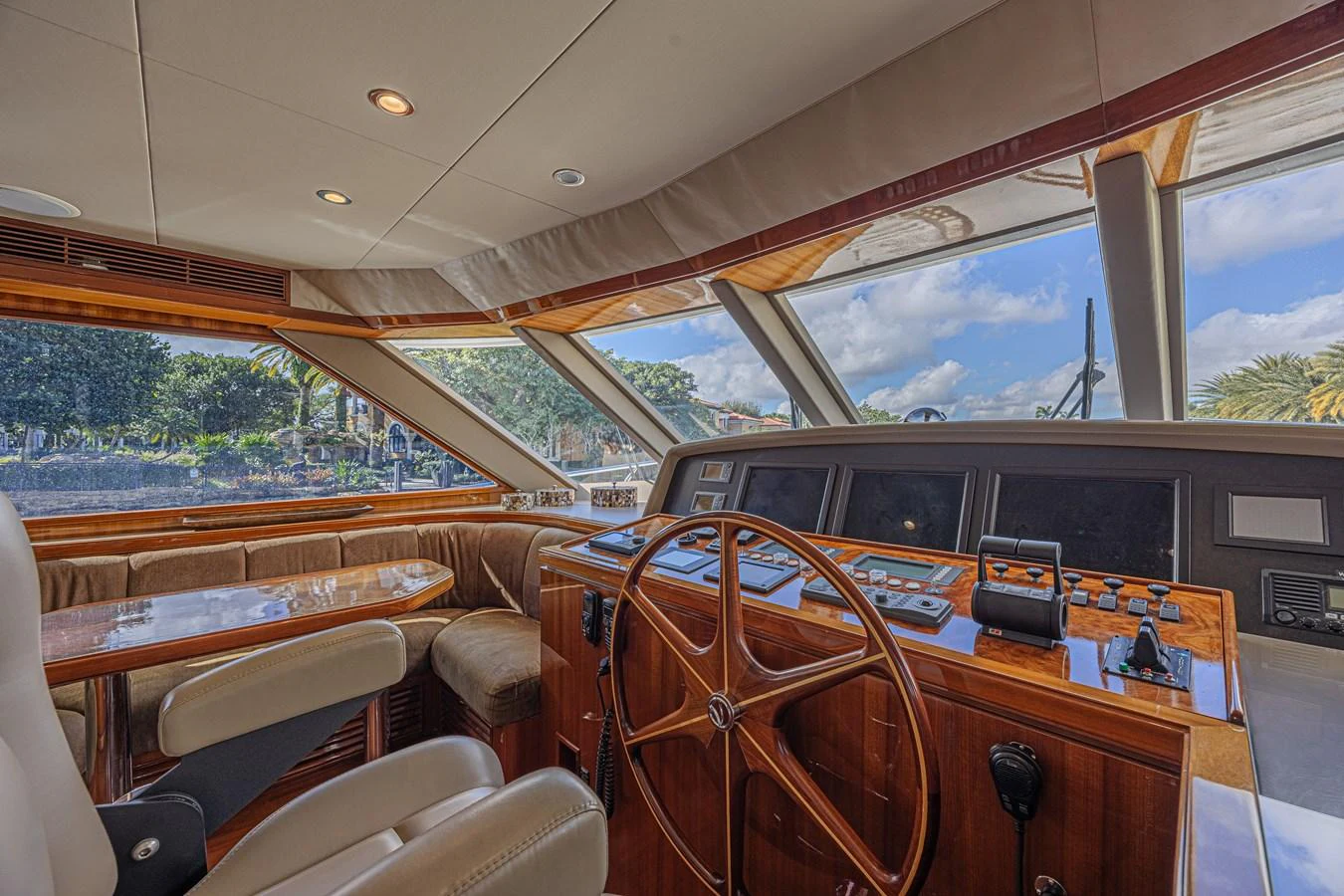 The helm station features a classic wooden steering wheel and modern navigation equipment, offering a blend of tradition and technology. aboard MARGARITA Yacht for Sale