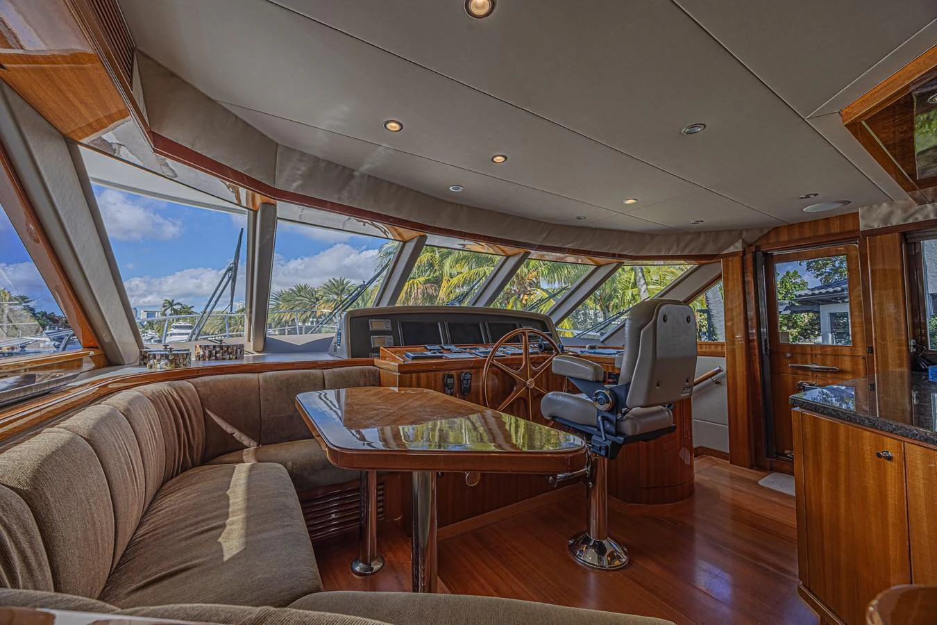 The helm area features a luxurious seating arrangement with panoramic windows offering stunning views. aboard MARGARITA Yacht for Sale