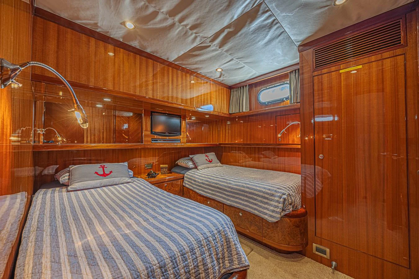 The guest stateroom features twin beds with nautical-themed decor and warm wood paneling. aboard MARGARITA Yacht for Sale