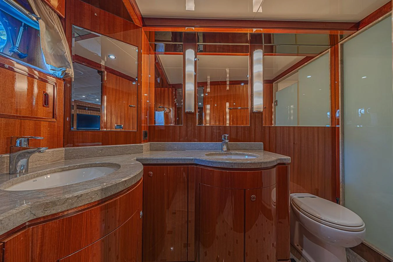 The yacht's bathroom features elegant wood paneling and modern fixtures. aboard MARGARITA Yacht for Sale