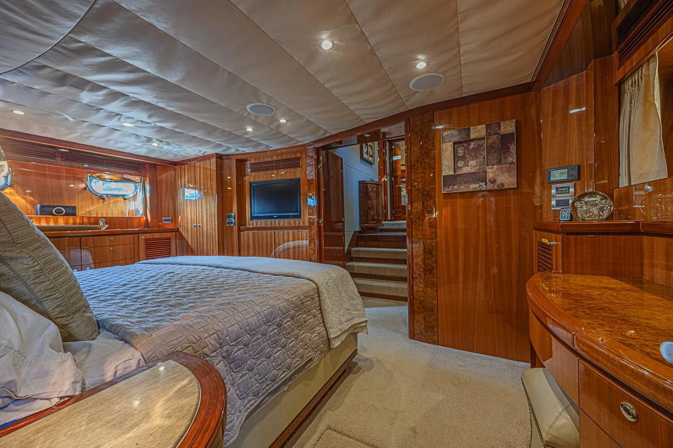 The stateroom features luxurious wood paneling, a comfortable bed, and modern amenities for a relaxing stay. aboard MARGARITA Yacht for Sale