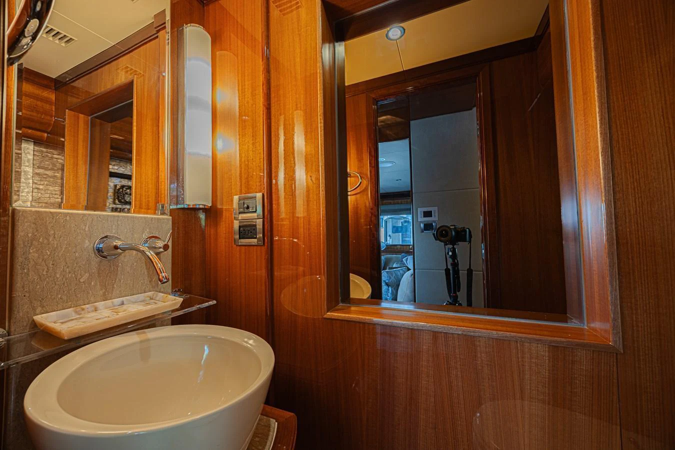 The yacht's bathroom features elegant wood paneling and modern fixtures. aboard MARGARITA Yacht for Sale