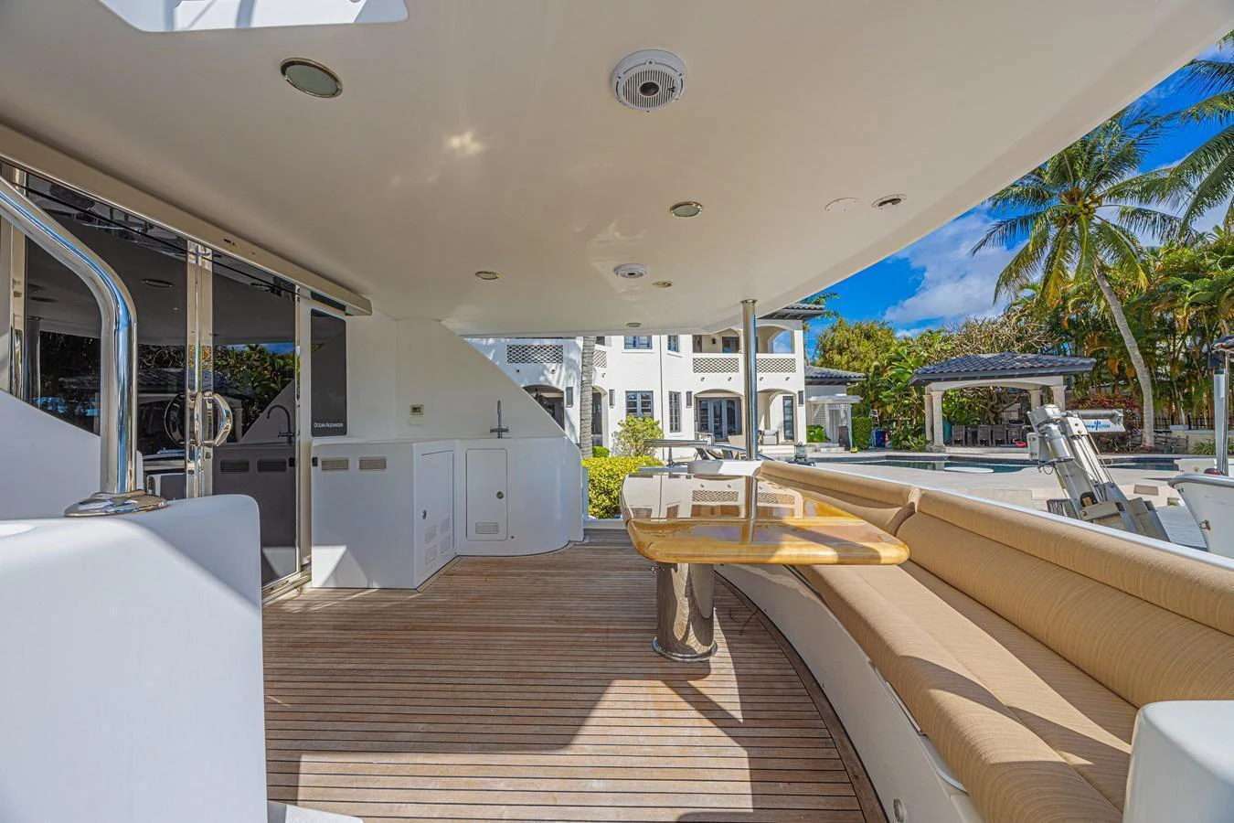 The aft deck features a spacious seating area with a wooden table, perfect for outdoor relaxation and dining. aboard MARGARITA Yacht for Sale