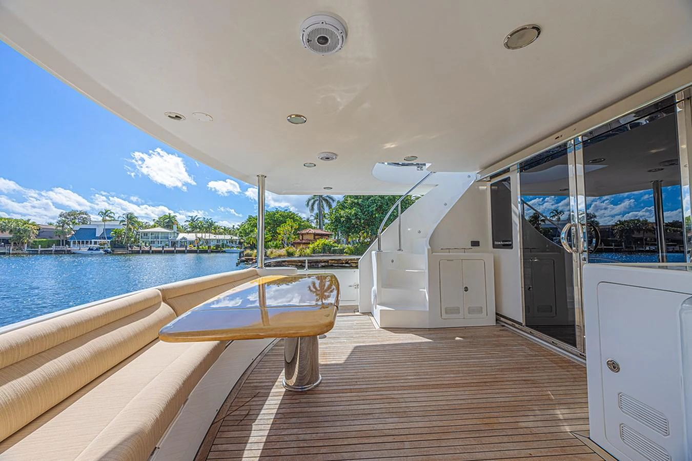 The aft deck features a spacious seating area with a polished wooden table, perfect for alfresco dining. aboard MARGARITA Yacht for Sale