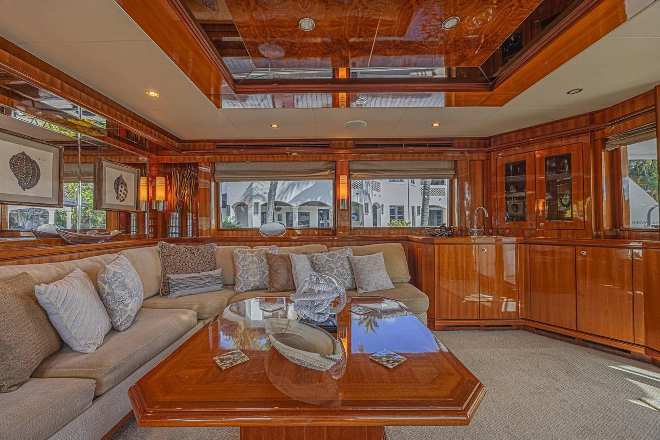 The salon features luxurious wood finishes, plush seating, and large windows for natural light. aboard MARGARITA Yacht for Sale