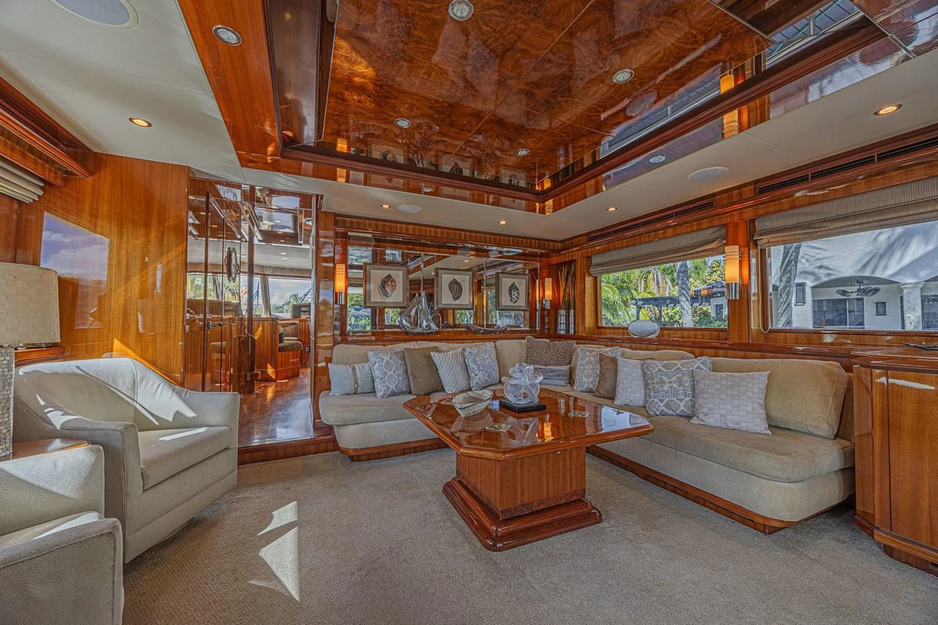 The salon features luxurious seating with elegant wood finishes and ample natural light. aboard MARGARITA Yacht for Sale