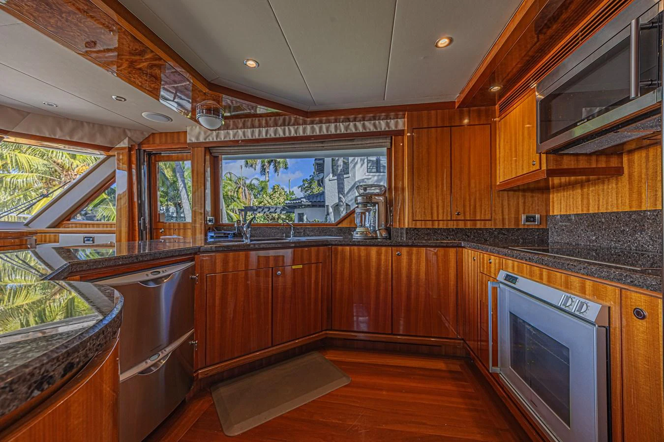 The yacht's galley features rich wooden cabinetry, modern appliances, and ample counter space, creating a warm and functional cooking area. aboard MARGARITA Yacht for Sale