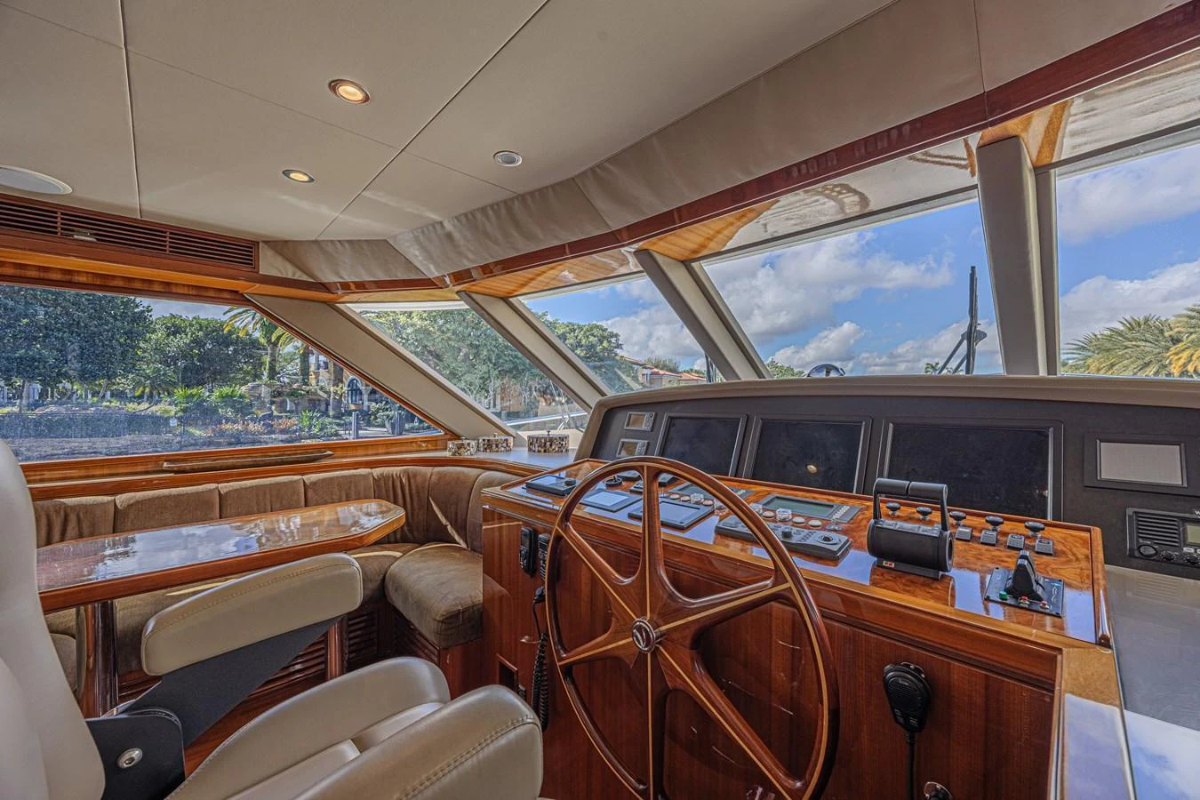 The helm station features a classic wooden steering wheel and modern navigation equipment, offering a blend of tradition and technology. aboard MARGARITA Yacht for Sale