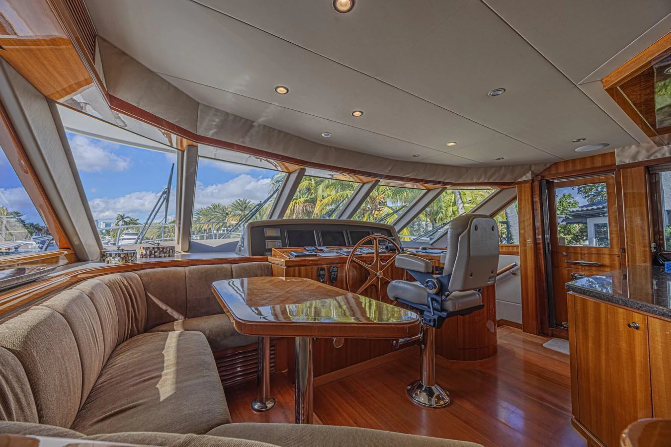 The helm area features a luxurious seating arrangement with panoramic windows offering stunning views. aboard MARGARITA Yacht for Sale