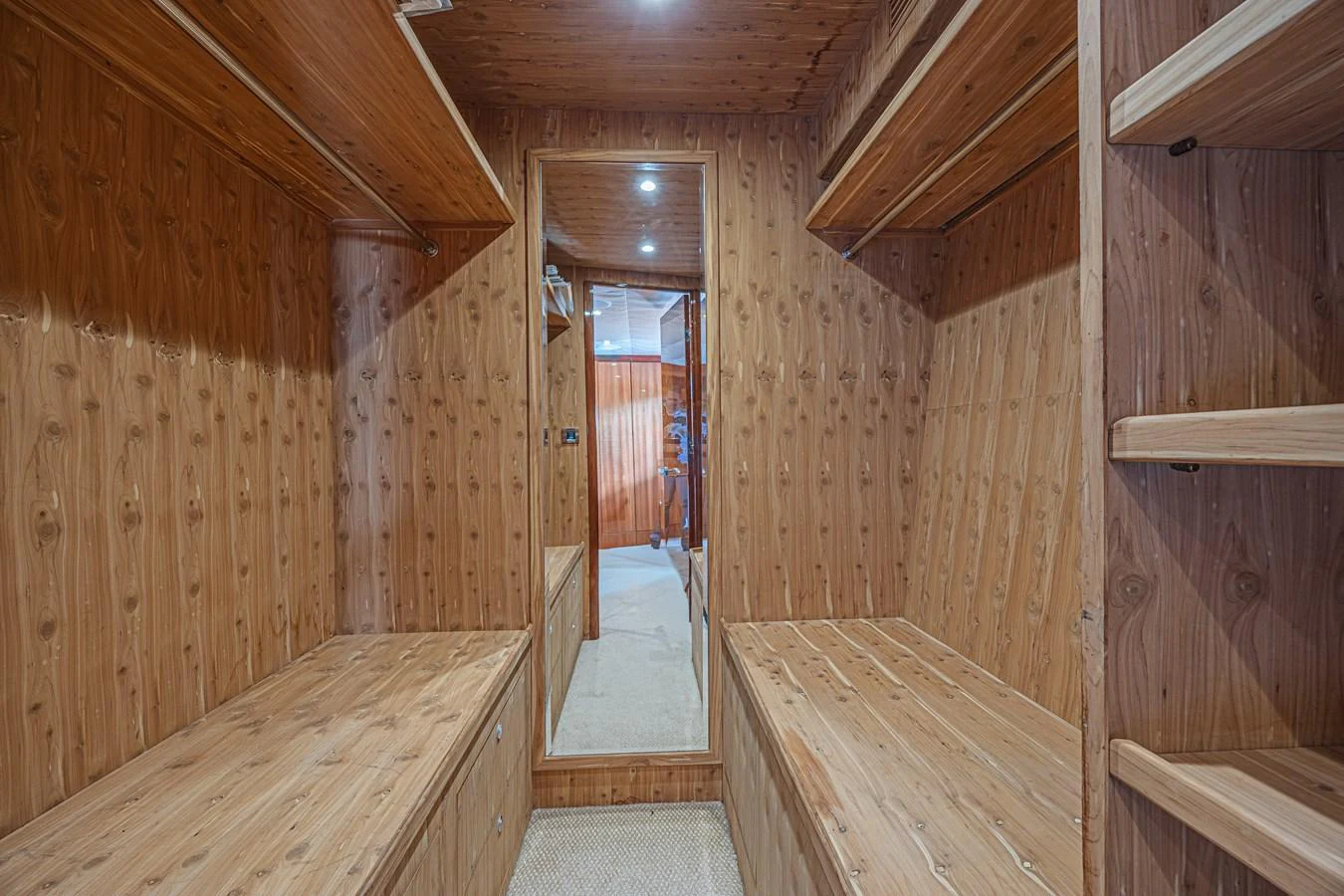 The yacht's interior features a cozy wooden room with built-in benches and shelves, creating a warm and inviting atmosphere. aboard MARGARITA Yacht for Sale