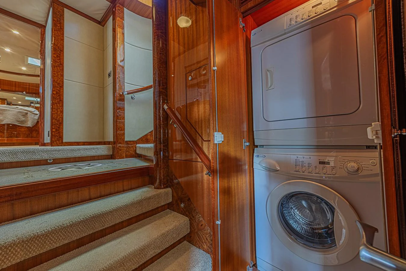 The yacht features a convenient laundry area with a stacked washer and dryer. aboard MARGARITA Yacht for Sale