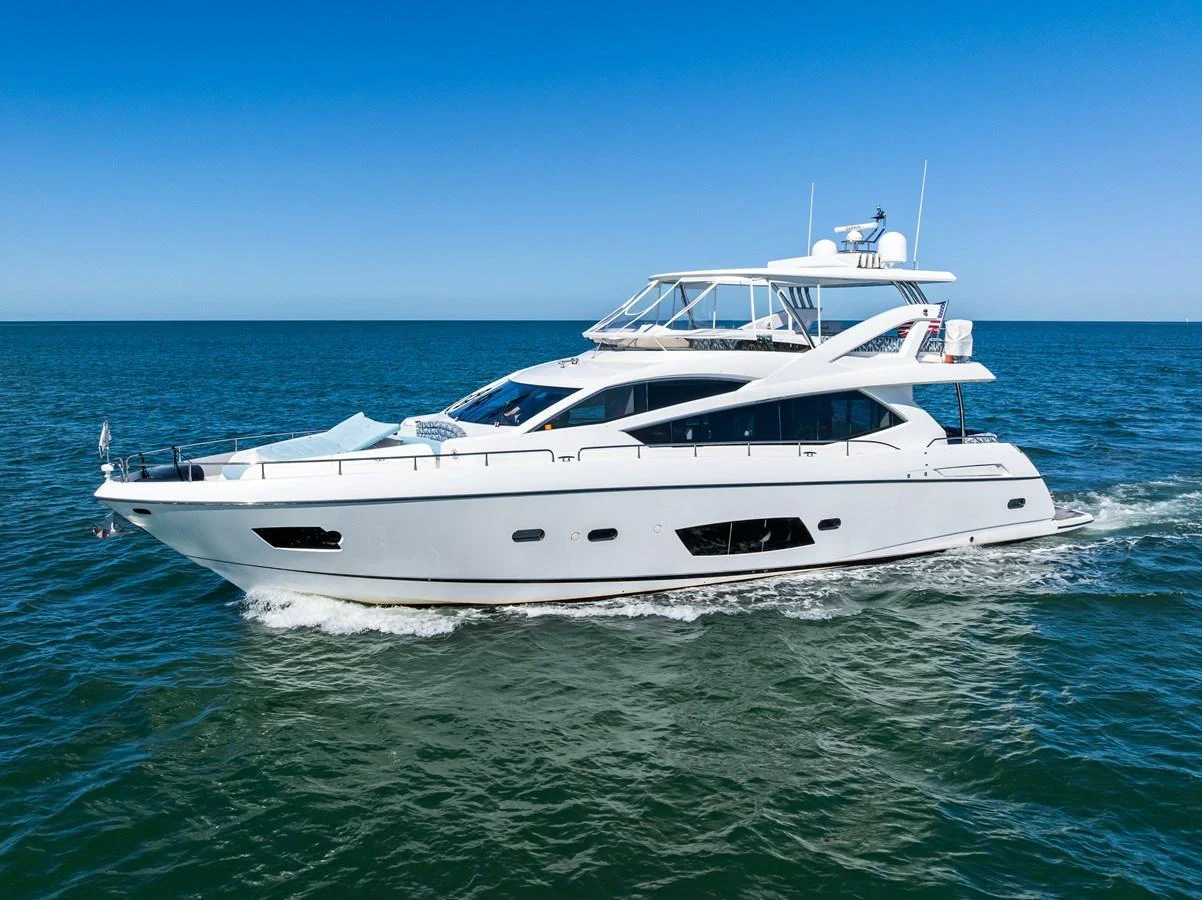 A sleek and modern yacht cruising on the open water under a clear blue sky. aboard IT'S ENOUGH Yacht for Sale