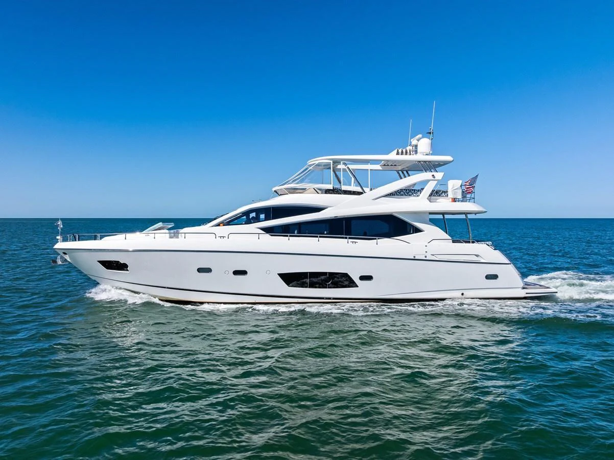 A sleek and modern yacht cruising on open waters under a clear blue sky. aboard IT'S ENOUGH Yacht for Sale