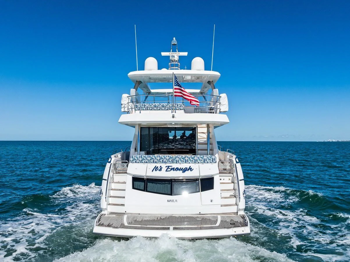 A luxurious yacht cruises on the open sea, showcasing its elegant design and spacious decks. aboard IT'S ENOUGH Yacht for Sale