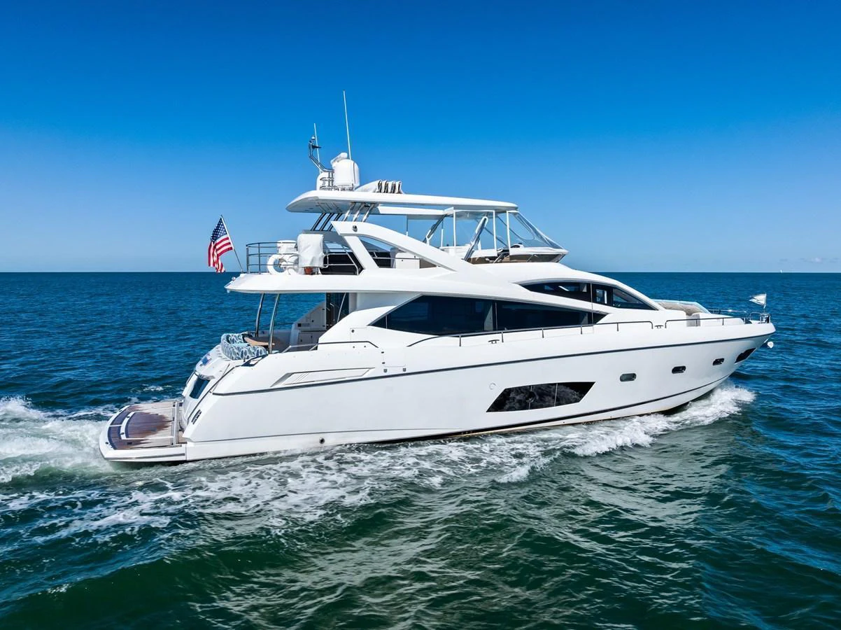 A sleek and modern yacht cruising on open waters under a clear blue sky. aboard IT'S ENOUGH Yacht for Sale