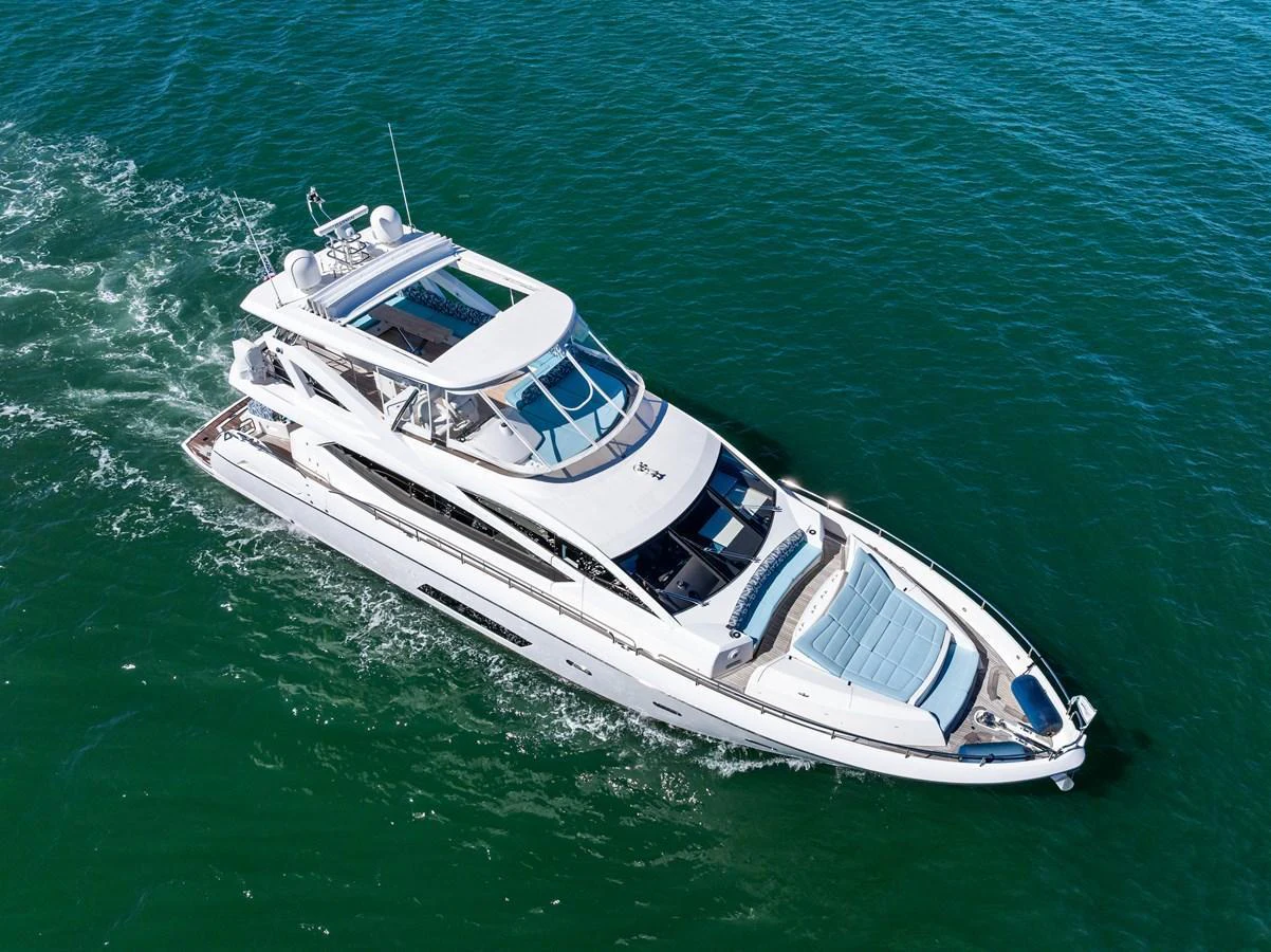 A sleek and modern yacht cruising through clear blue waters. aboard IT'S ENOUGH Yacht for Sale
