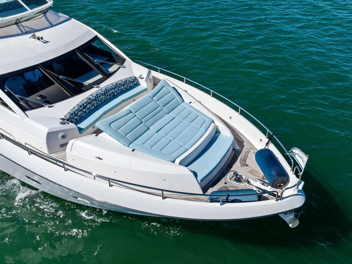 The yacht's bow features luxurious sun pads and a sleek design, perfect for relaxation on the water. aboard IT'S ENOUGH Yacht for Sale