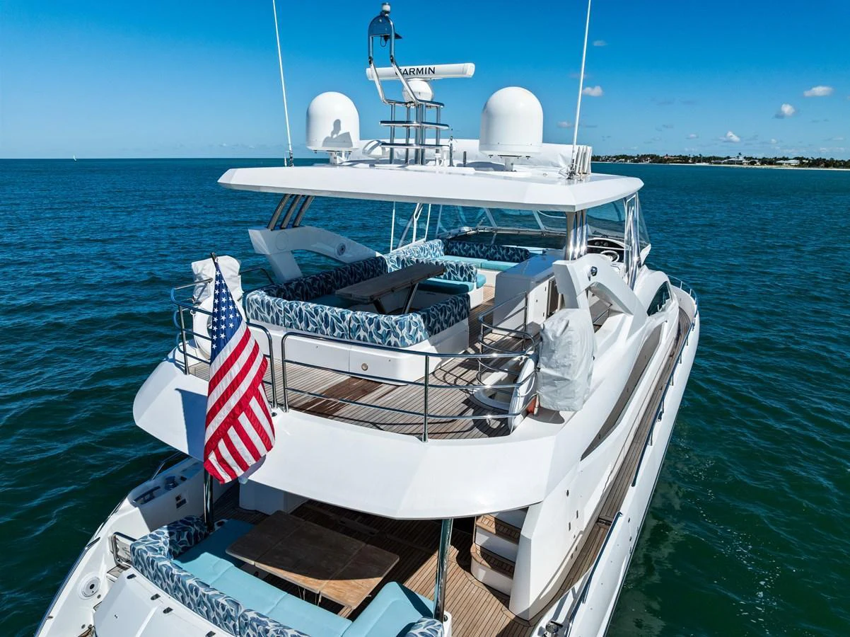 The yacht's aft deck offers a spacious and inviting area for relaxation and socializing, with ample seating and a stunning view of the open sea. aboard IT'S ENOUGH Yacht for Sale