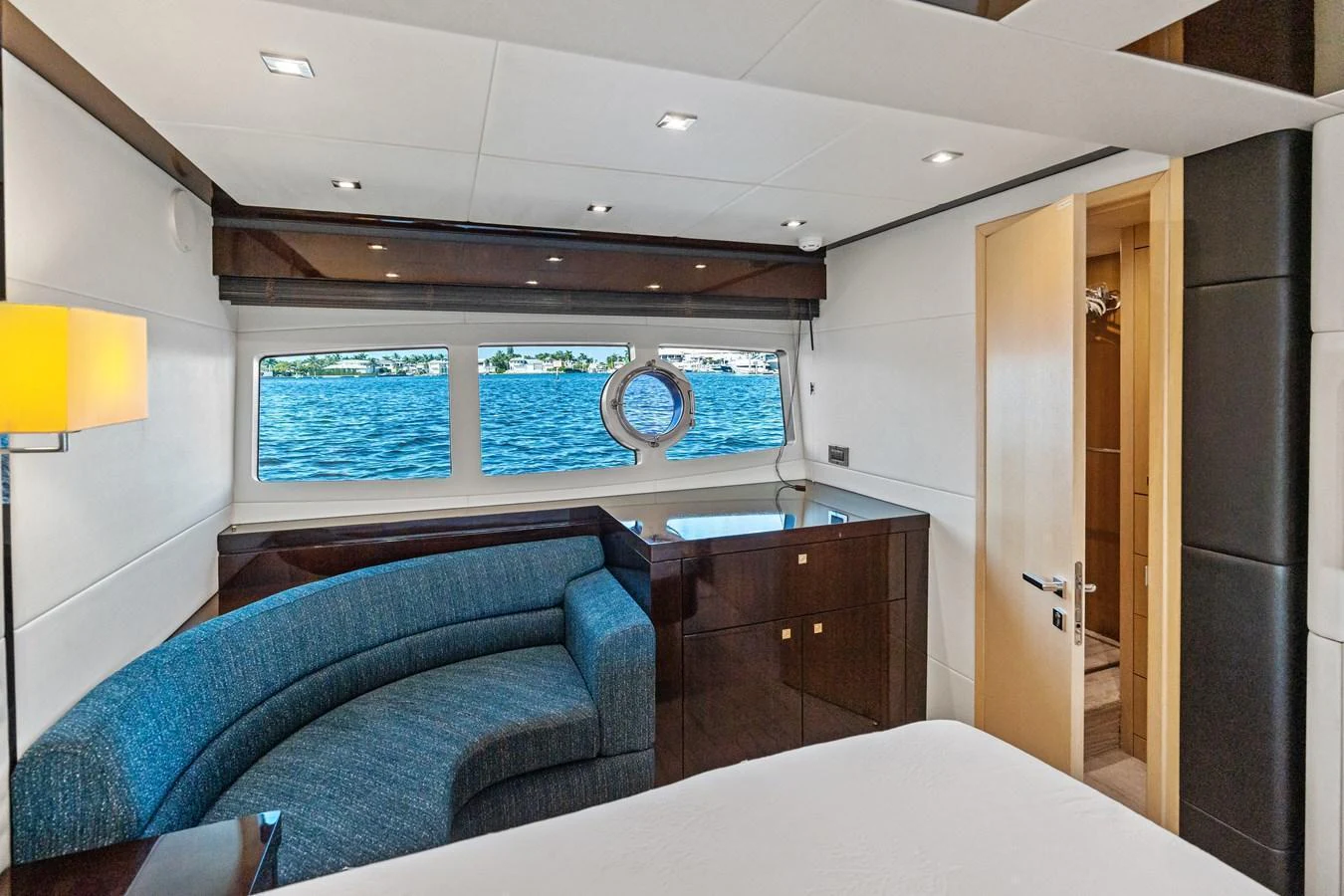 A luxurious stateroom with a large window offering a stunning view of the sea. aboard IT'S ENOUGH Yacht for Sale