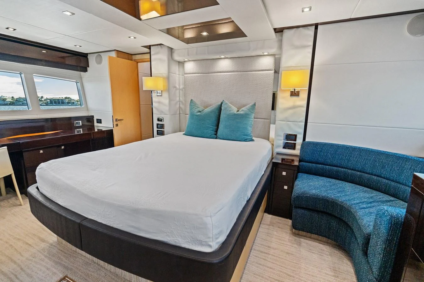 The master stateroom features a spacious bed, elegant lighting, and a comfortable seating area. aboard IT'S ENOUGH Yacht for Sale
