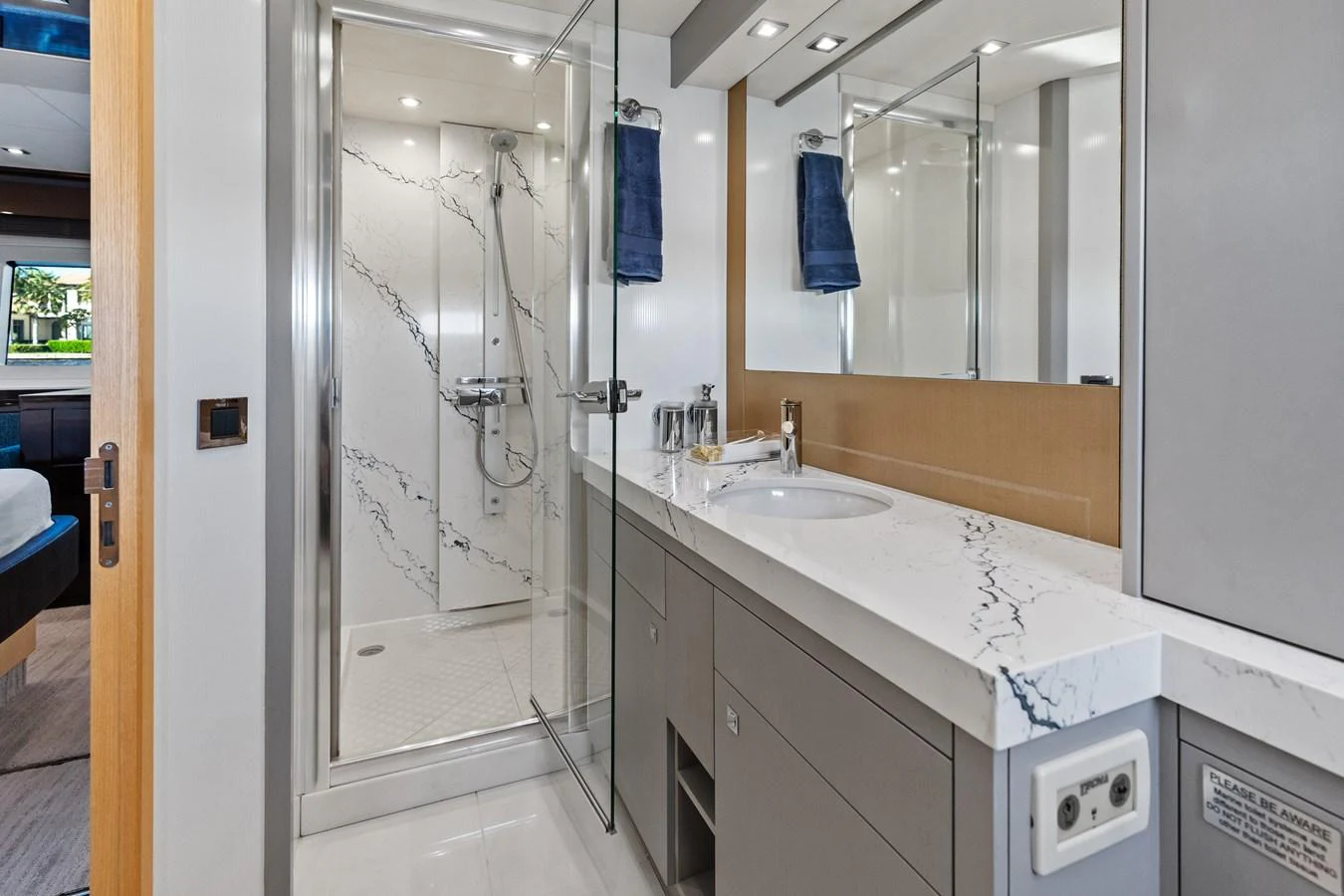 The yacht's bathroom features a sleek design with a spacious shower and modern fixtures. aboard IT'S ENOUGH Yacht for Sale