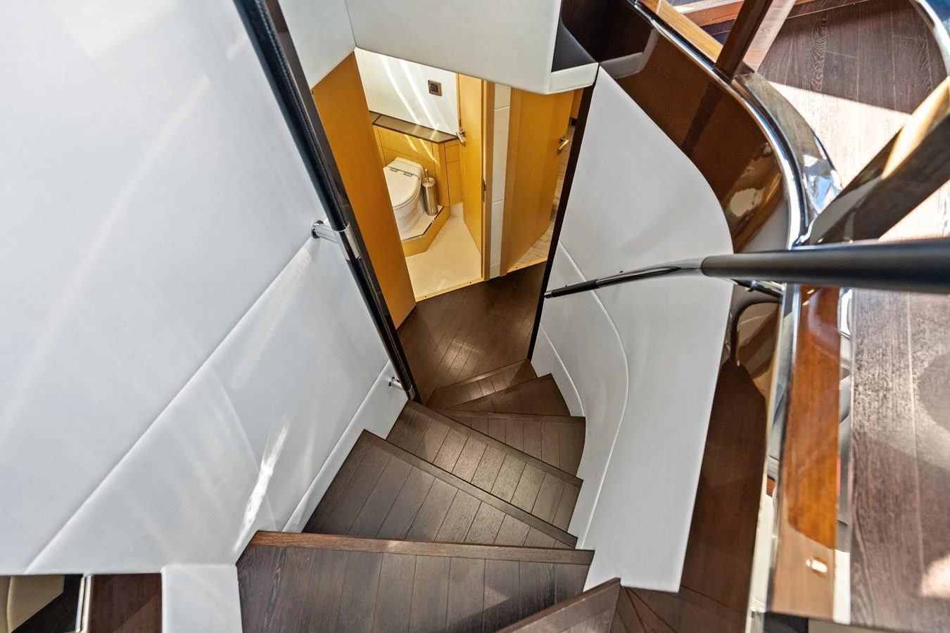 A sleek and modern staircase leads down to the lower deck, showcasing elegant design and craftsmanship. aboard IT'S ENOUGH Yacht for Sale