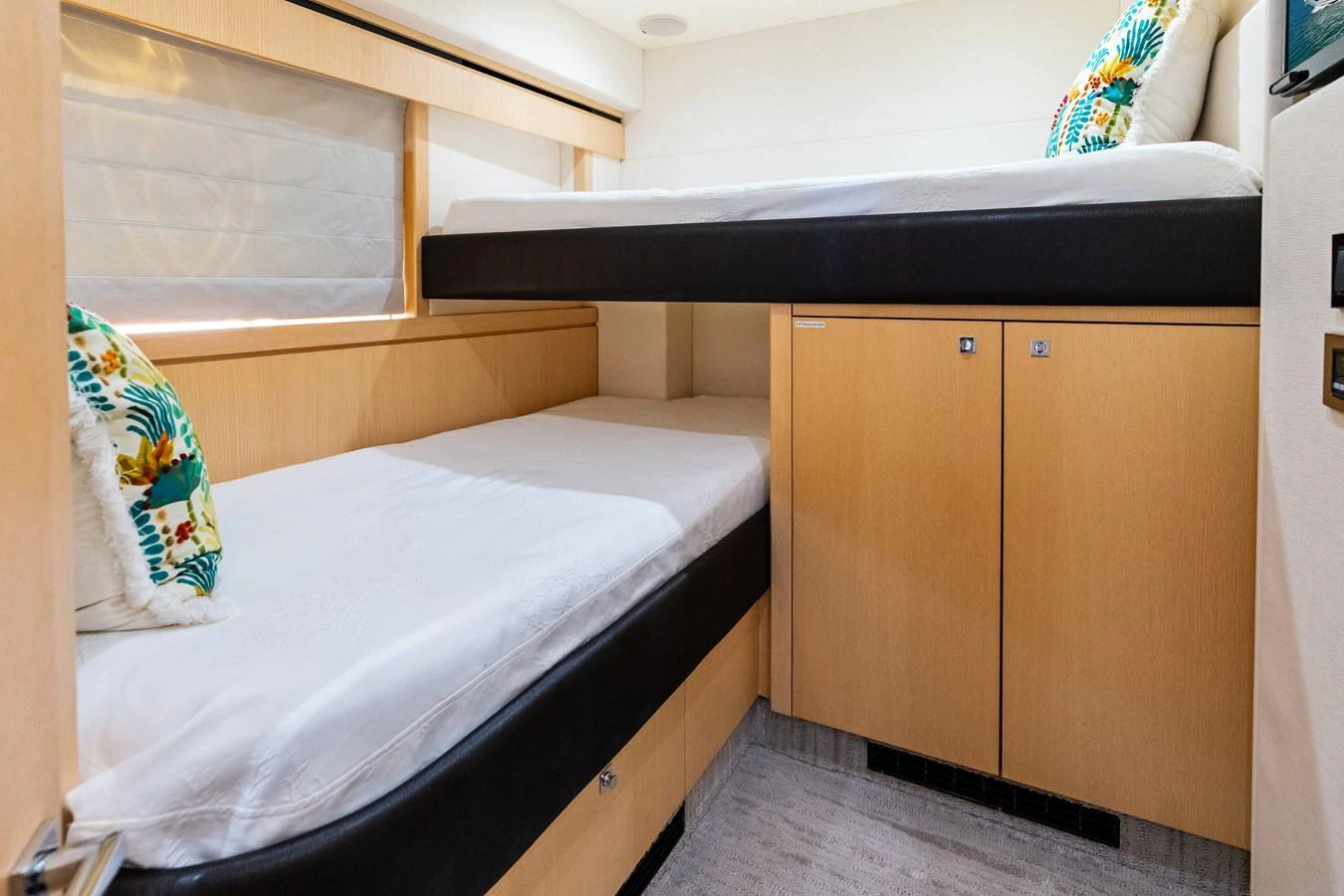 The guest cabin features cozy twin bunk beds with stylish decor and ample storage. aboard IT'S ENOUGH Yacht for Sale