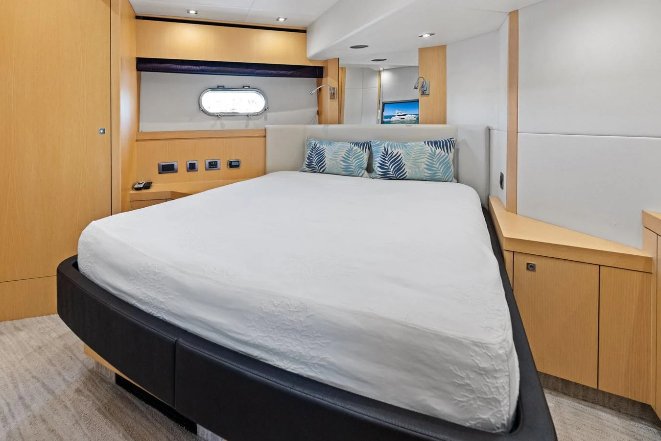 The stateroom features a comfortable bed with modern furnishings and a window view. aboard IT'S ENOUGH Yacht for Sale
