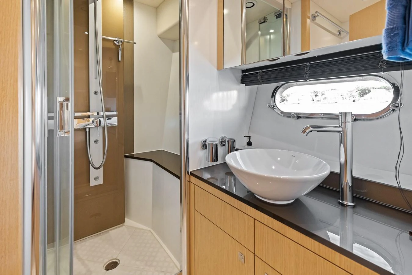 The yacht's bathroom features a modern design with a sleek sink and a spacious shower area. aboard IT'S ENOUGH Yacht for Sale