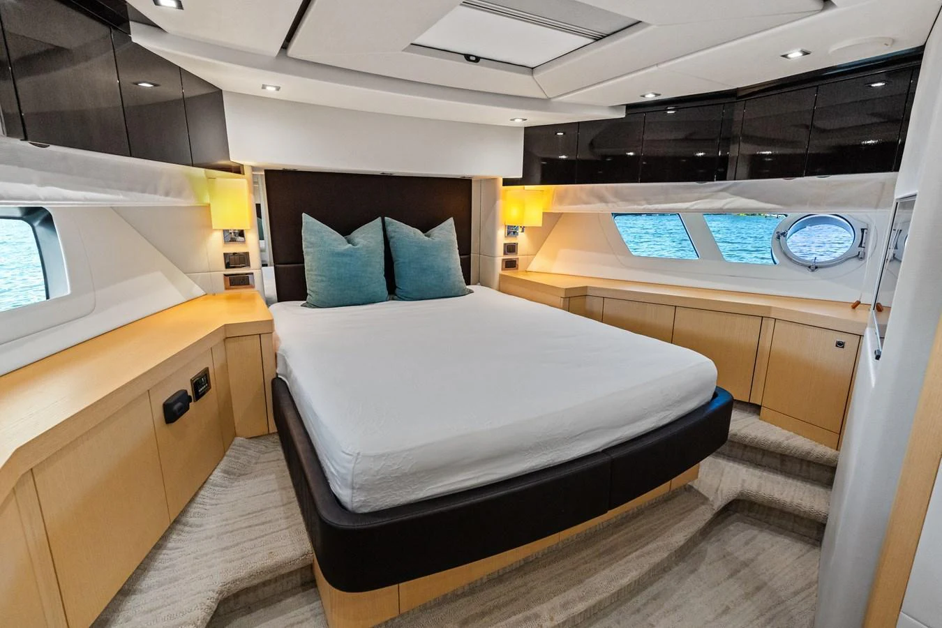 A luxurious stateroom with a large bed and elegant lighting. aboard IT'S ENOUGH Yacht for Sale