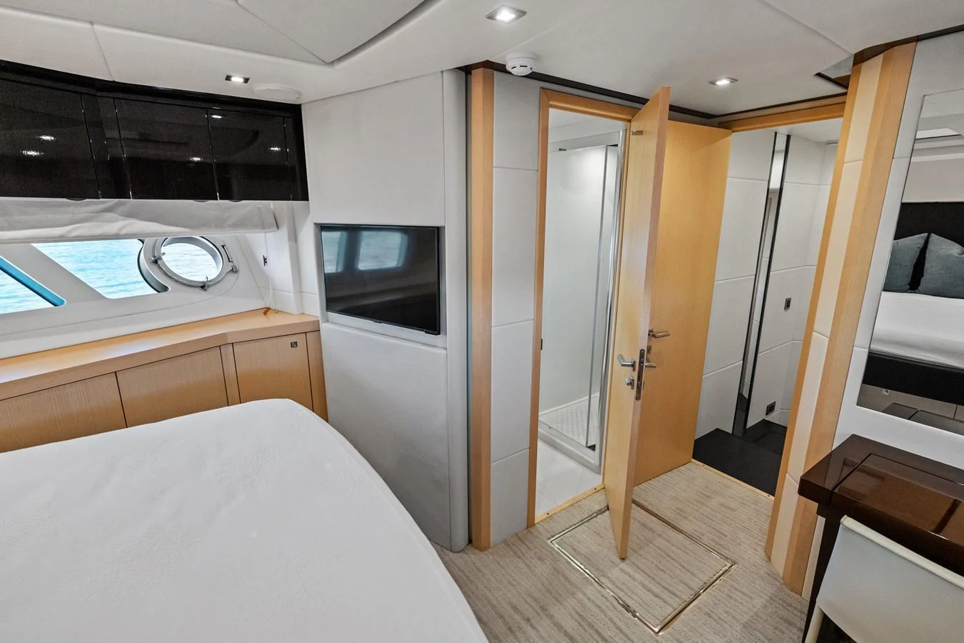 The stateroom features a cozy bed, a porthole window, and an ensuite bathroom for ultimate comfort. aboard IT'S ENOUGH Yacht for Sale