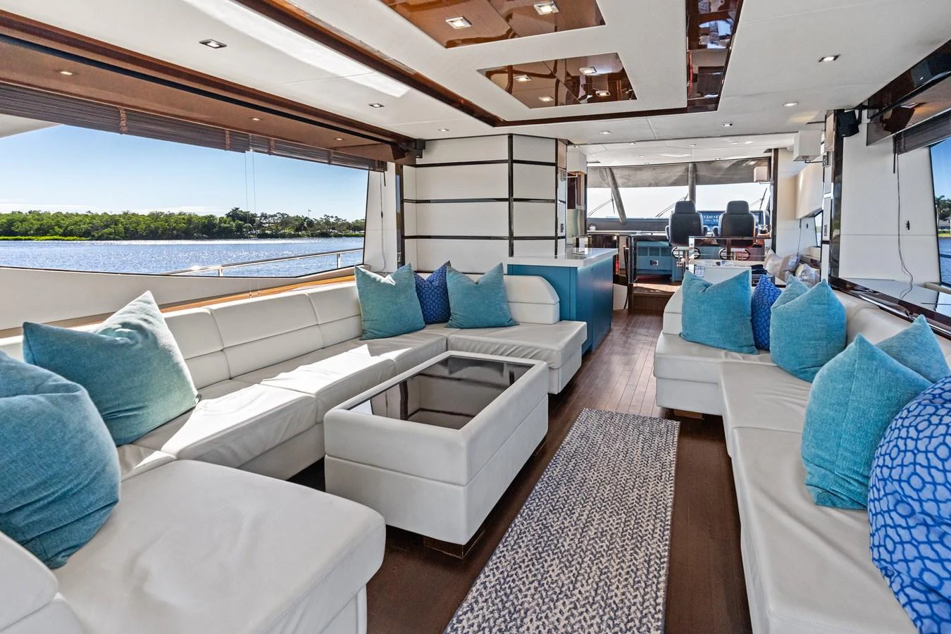 The spacious salon features luxurious seating with a panoramic view of the water. aboard IT'S ENOUGH Yacht for Sale
