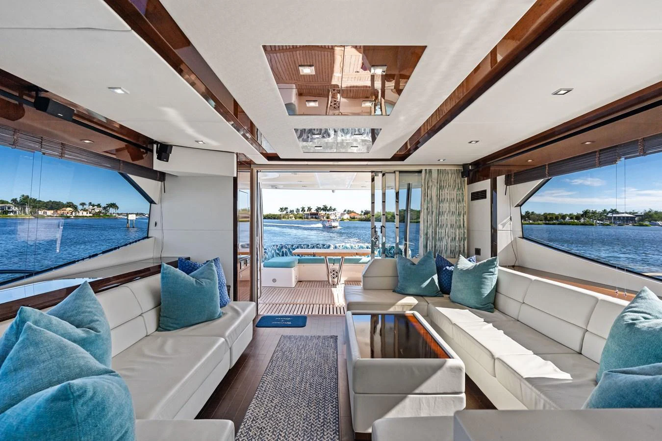 The salon features luxurious seating with panoramic views of the water. aboard IT'S ENOUGH Yacht for Sale
