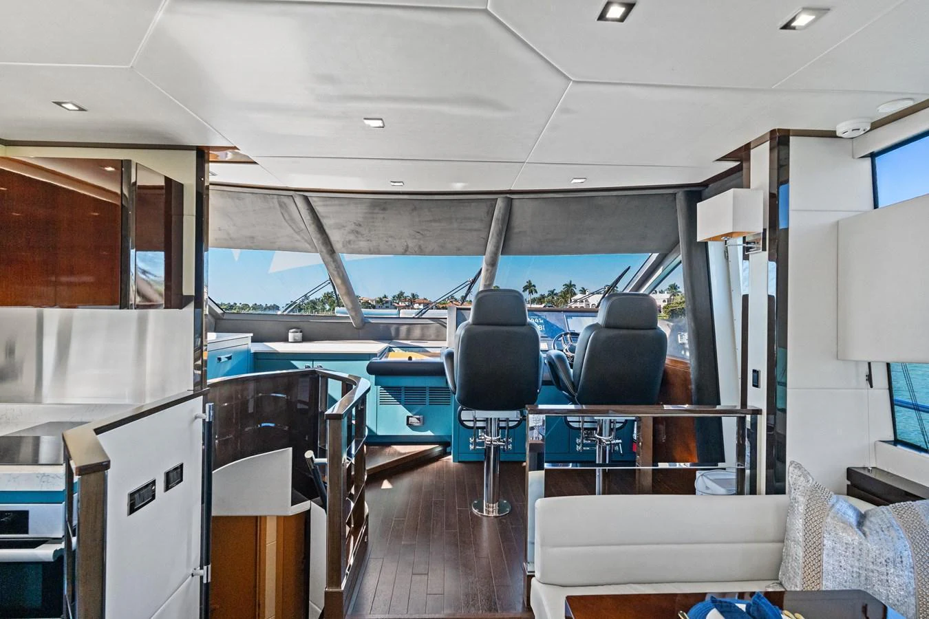 The yacht's helm area features modern controls and comfortable seating with panoramic views. aboard IT'S ENOUGH Yacht for Sale