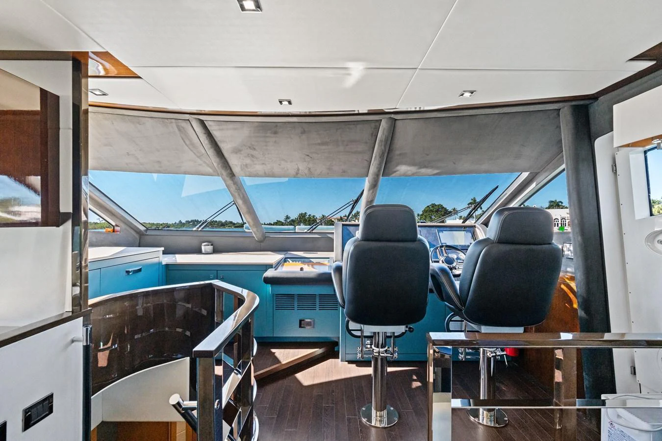 The helm station offers a commanding view with modern controls and comfortable seating. aboard IT'S ENOUGH Yacht for Sale