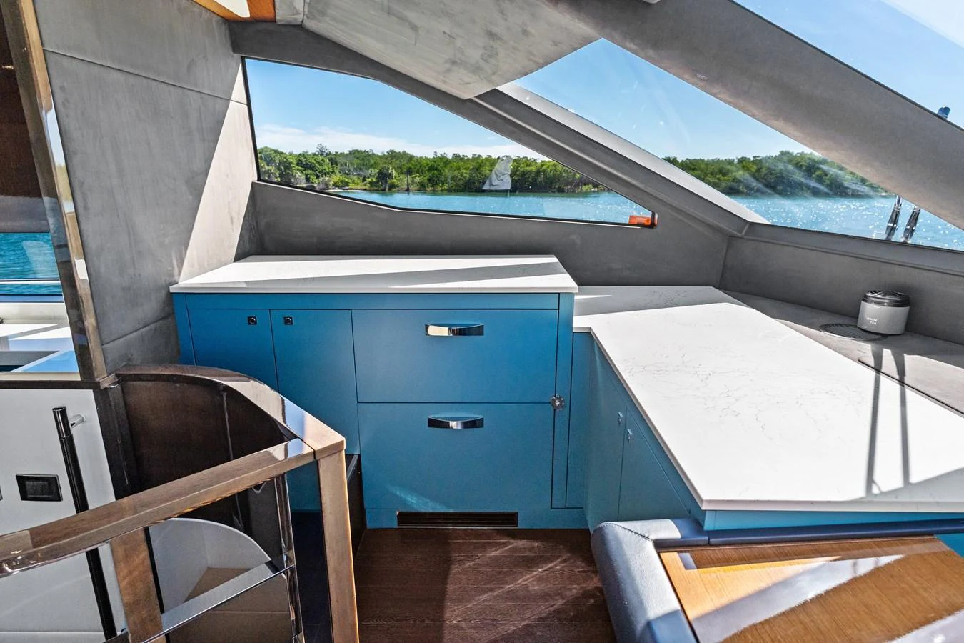 The yacht's interior features a sleek, modern design with large windows offering stunning views of the water. aboard IT'S ENOUGH Yacht for Sale