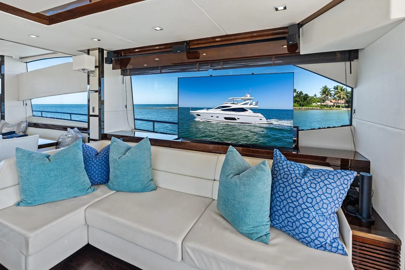 The salon features a comfortable seating area with a view of the sea through large windows. aboard IT'S ENOUGH Yacht for Sale