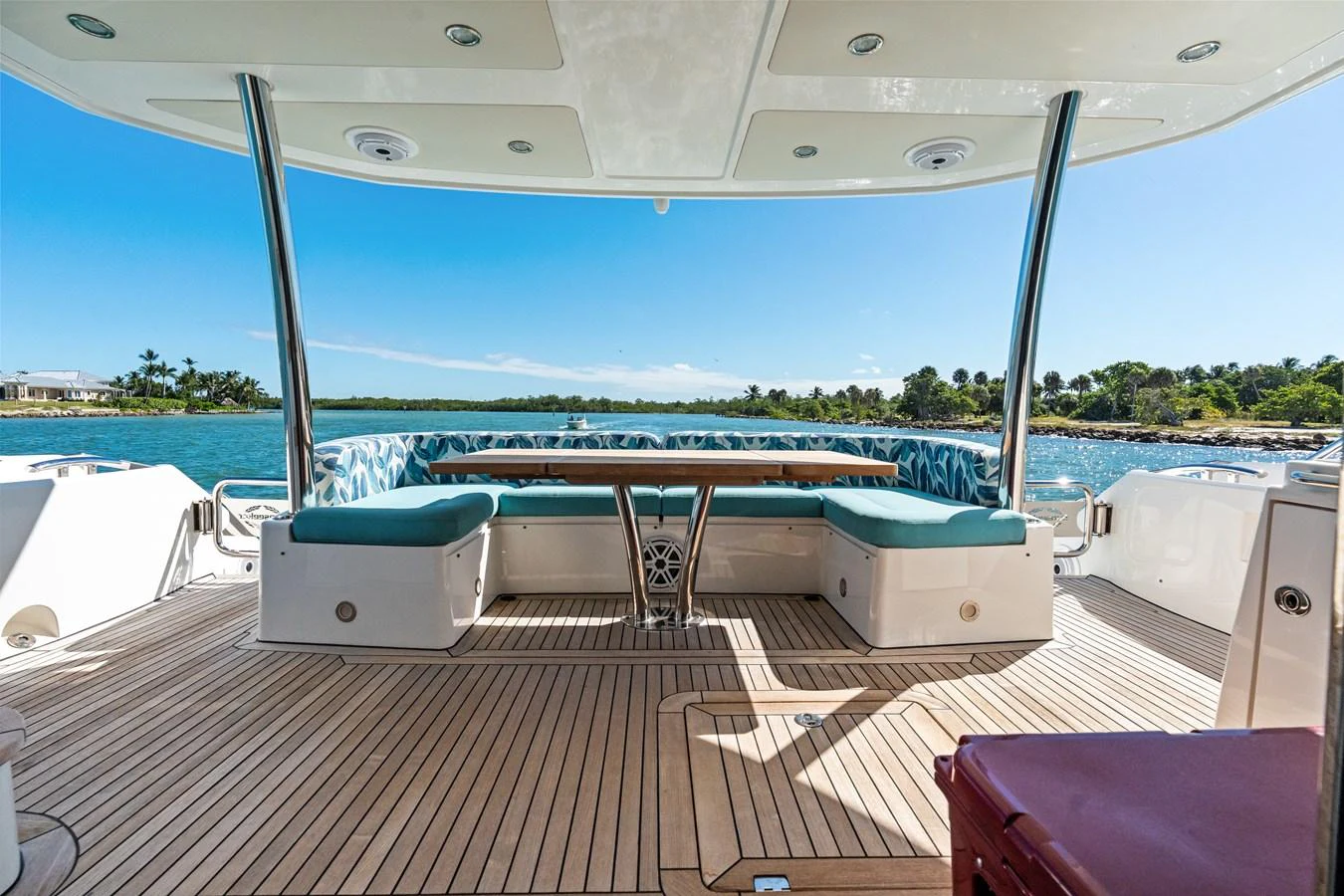 The aft deck features comfortable seating and a dining area with a stunning view of the water. aboard IT'S ENOUGH Yacht for Sale