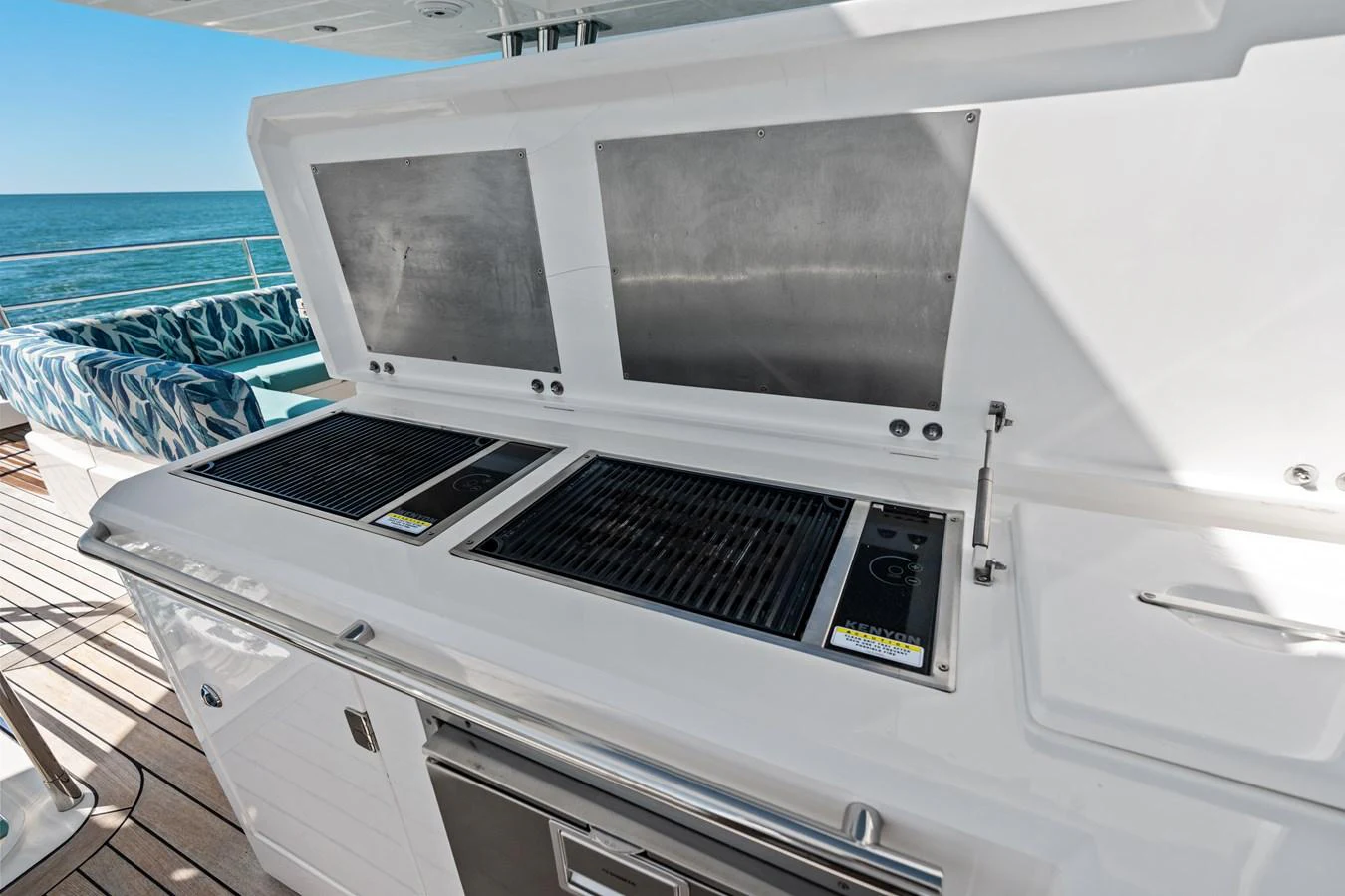 The yacht features a well-equipped outdoor galley with dual grills and ample counter space, perfect for alfresco dining. aboard IT'S ENOUGH Yacht for Sale