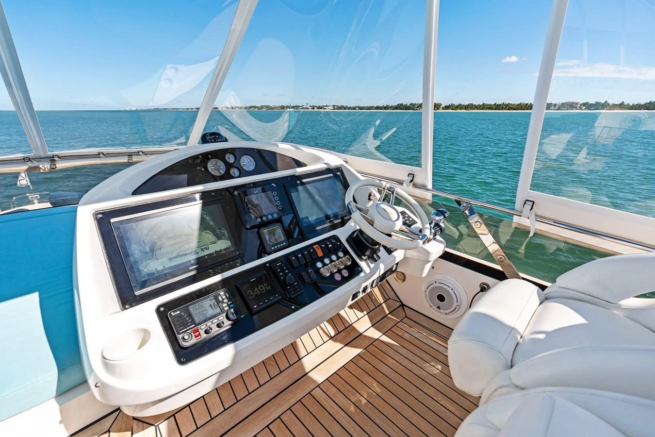 The helm offers a panoramic view with state-of-the-art navigation equipment and luxurious seating. aboard IT'S ENOUGH Yacht for Sale