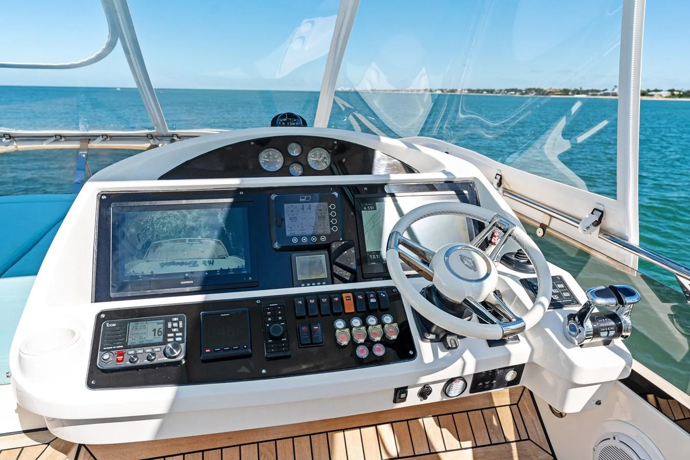The helm station offers a sophisticated control panel with state-of-the-art navigation equipment and a sleek steering wheel. aboard IT'S ENOUGH Yacht for Sale
