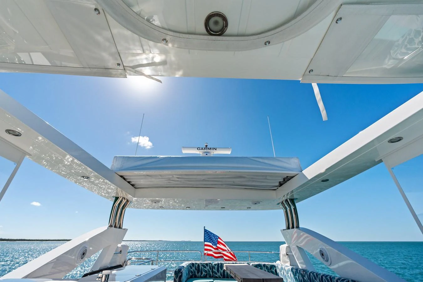 The aft deck offers a stunning view of the open sea with ample seating and shade. aboard IT'S ENOUGH Yacht for Sale